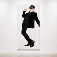 A large vertical Original painting by Orit Fuchs  featuring a stylized illustration of a man in a black suit, displayed on a white gallery wall.